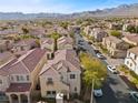 Aerial view of houses and street, showcasing community and mountain views at 1032 Campo Seco Ct, Las Vegas, NV 89138