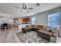 Open living room with L-shaped sectional sofa and adjacent kitchen at 152 Belmont Canyon Pl, Henderson, NV 89015