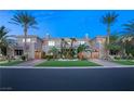Elegant two-story home with palm trees and manicured lawn at 1549 Foothills Village Dr, Henderson, NV 89012