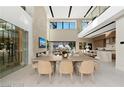 Spacious dining area with a large table and modern light fixtures at 168 Still Shores St, Henderson, NV 89011