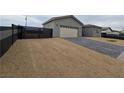 New construction home with modern gray exterior and black gate at 1770 Ironside St, Pahrump, NV 89048
