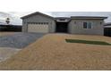 Contemporary home with neutral exterior and paver driveway at 1770 Ironside St, Pahrump, NV 89048
