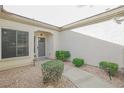 Front entry with walkway, landscaping, and a gray door at 2951 Maffie St, Henderson, NV 89052