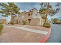Exterior shot of condo building with well-maintained landscaping at 2983 Juniper Hills Blvd # 102, Las Vegas, NV 89142
