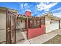 Inviting entryway featuring decorative ironwork, brick accents, and a secure gated entry at 4720 E Wyoming Ave, Las Vegas, NV 89104