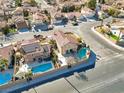 Sprawling aerial view of homes on a block featuring pools, spas, solar panels, and well-manicured lawns at 4726 Beaconsfield St, Las Vegas, NV 89147