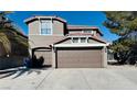 Two-story house with a brown two-car garage and palm trees at 6538 W Mesa Vista Ave, Las Vegas, NV 89118