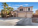 Two-story house with a three-car garage and desert landscaping at 6916 Snow Finch St, North Las Vegas, NV 89084