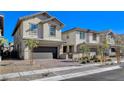 Two-story house with gray siding, dark garage door, and landscaped front yard at 710 Bamboo Bend Pl, Henderson, NV 89011