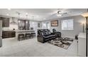 Open concept kitchen with island, stainless steel appliances, and dark cabinets at 710 Bamboo Bend Pl, Henderson, NV 89011