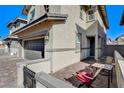 Cozy patio with seating area adjacent to the house and garage at 710 Bamboo Bend Pl, Henderson, NV 89011
