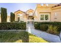 House entrance with a white gate and well-manicured hedges at 7943 Harbour Towne Ave, Las Vegas, NV 89113