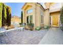 Inviting patio with white metal furniture and brick pavers at 7943 Harbour Towne Ave, Las Vegas, NV 89113