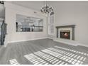 Bright living room featuring a fireplace and hardwood floors at 8232 Ocean Terrace Way, Las Vegas, NV 89128