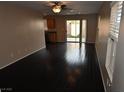 Inviting living room boasts dark hardwood floors, neutral walls, and sliding glass doors at 10264 Headrick Dr, Las Vegas, NV 89166