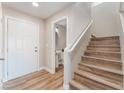 Entryway with stairs, powder room, and light wood flooring at 1512 Groom Ave, North Las Vegas, NV 89081