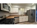 Updated kitchen featuring stainless steel appliances and granite countertops at 2136 Chertsey Dr # A, Las Vegas, NV 89108