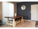 The dining area features a farmhouse table with bench seating and a modern round mirror at 2509 Piacenza Pl, Henderson, NV 89044