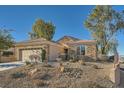 Single-story home with stone and stucco exterior, two-car garage, and drought-tolerant landscaping at 2551 Darda St, Henderson, NV 89044