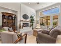 Spacious living room with a fireplace and large windows at 2575 Grassy Spring Pl, Las Vegas, NV 89135