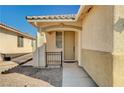 Front entrance with a covered porch and wrought iron gate at 3060 Lapis Beach Dr, Las Vegas, NV 89117