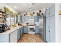 Bright kitchen with light blue cabinets and tile floor at 3119 Crownline Ct, North Las Vegas, NV 89031