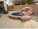 Backyard oasis with a spa and waterfall feature at 3310 Fernbird Ln, North Las Vegas, NV 89084