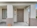 Front door with a brown metal security door and a porch light at 3708 Penny Cross Dr, North Las Vegas, NV 89032