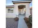 Front porch with a bench, leading to the entrance at 3717 Seneca Highland St, North Las Vegas, NV 89032