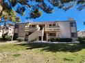 Two-story building with Spanish tile roofs, balconies, and a grassy yard at 3800 Desert Marina Dr # 160, Laughlin, NV 89029