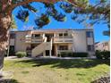 Two-story building with Spanish tile roofs, balconies, and a grassy yard at 3800 Desert Marina Dr # 160, Laughlin, NV 89029