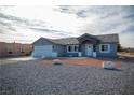 Charming single-story house featuring a two-car garage, gravel yard, and minimalist desert landscaping at 3960 Dart Dr, Pahrump, NV 89060