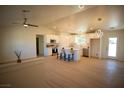 Modern kitchen with white cabinets, island, stainless steel appliances, and light flooring at 3960 Dart Dr, Pahrump, NV 89060