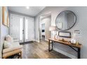 Bright and airy entryway with wood-look floors and bench at 4182 Bottiglia Ave, Las Vegas, NV 89141