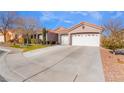 Front view of a house with a two-car garage and landscaping at 4182 Bottiglia Ave, Las Vegas, NV 89141