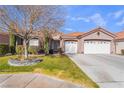 House exterior featuring a two-car garage and mature tree in front at 4182 Bottiglia Ave, Las Vegas, NV 89141