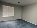 Cozy bedroom with neutral walls, carpet, and a large window offering ample natural light at 4707 Nara Vista Way # 104, Las Vegas, NV 89103