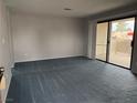 Bright living room featuring plush carpeting and sliding door access to a private balcony at 4707 Nara Vista Way # 104, Las Vegas, NV 89103