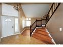 Bright entryway with wood stairs, tiled floor, and chandelier at 5508 Big Sky, Las Vegas, NV 89149