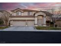 Two-story house with three-car garage and landscaped yard at 553 Sinfold Park St, Las Vegas, NV 89148