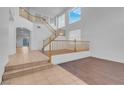 Bright foyer with staircase, tile entry, and hardwood flooring at 553 Sinfold Park St, Las Vegas, NV 89148