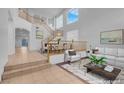 Bright living room with high ceilings and staircase with beautiful wood banister at 553 Sinfold Park St, Las Vegas, NV 89148