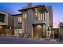 Contemporary two-story home with modern architectural details, a two-car garage, and desert landscaping at 577 Overlook Rim Dr, Henderson, NV 89012