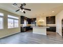 Open concept kitchen features dark wood cabinets and granite countertops at 6050 Belvedere Canyon Ave, Las Vegas, NV 89139