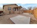 View of the stone front of the house with small porch and small yard, creating a cozy curb appeal at 628 L, Boulder City, NV 89005