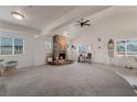 Spacious living room with a stone fireplace and high ceilings at 628 L, Boulder City, NV 89005