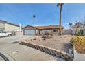 Landscaped front yard and driveway of a single-story house at 659 Glenwood Ln, Henderson, NV 89002