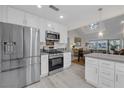 Modern kitchen with stainless steel appliances and white cabinetry at 6973 Emerald Springs Ln, Las Vegas, NV 89113