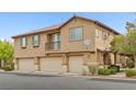 Tan two-story townhome with three-car garage at 7322 Fools Gold St # 101, Las Vegas, NV 89149