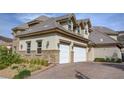 Large house with a three-car garage, stone accents, and landscaping at 768 Tozzetti Ln, Henderson, NV 89012